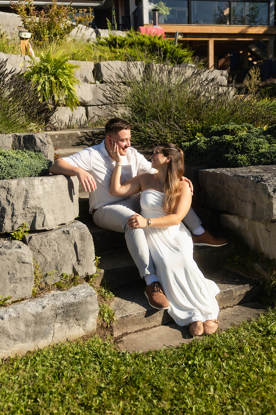 Andrew and Laura smiling together on stone steps