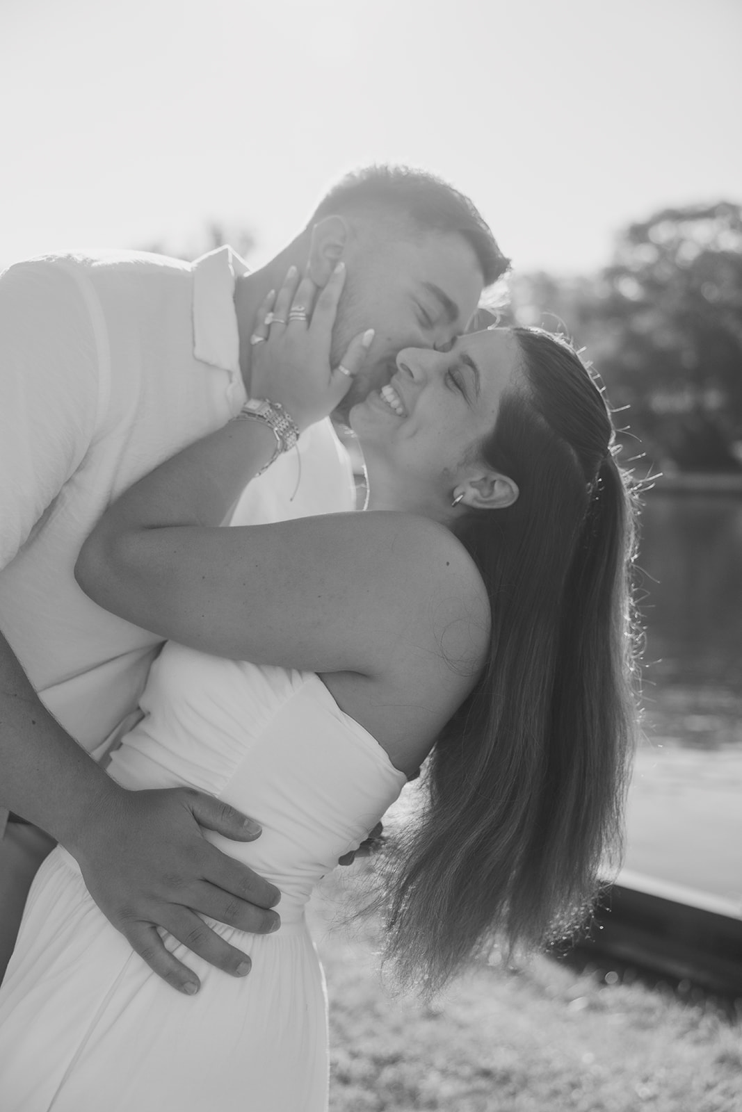Andrew and Laura laughing together in a black and white portrait